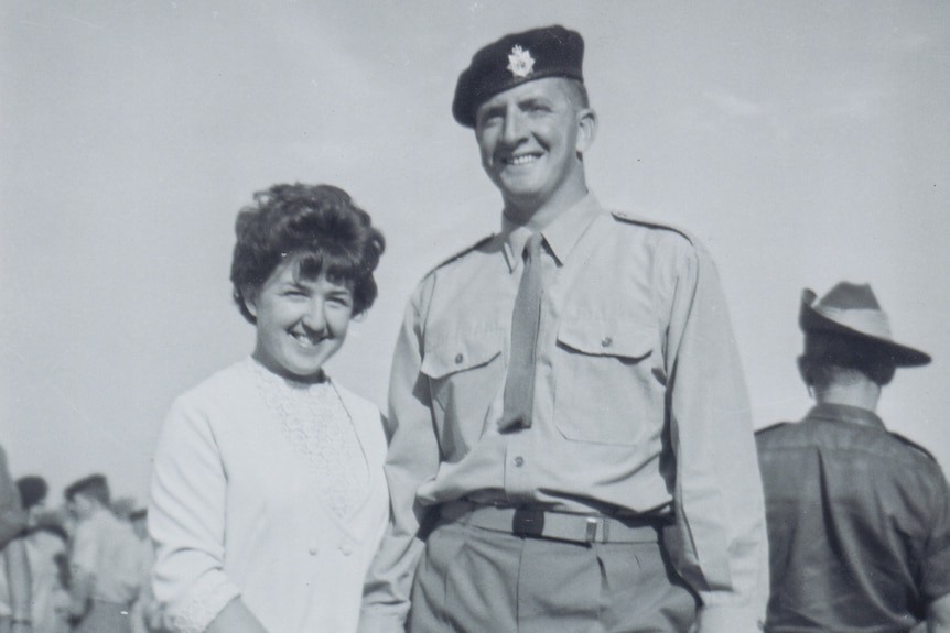 Black and white photo of Lindsay Wright in uniform with his wife.