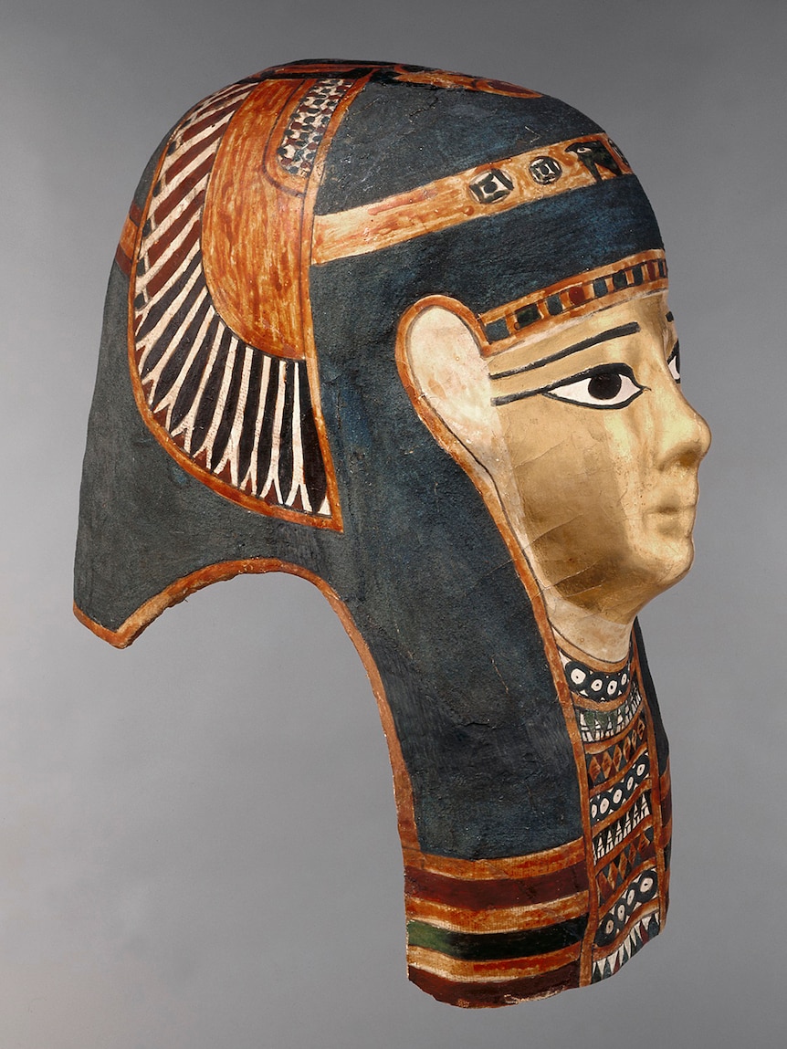 A side profile shot of an ancient Egyptian mask decorated with the Egyptian blue pigment
