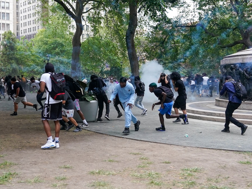 People running away from a smoke bomb