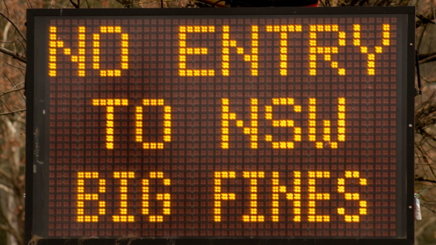 A electronic sign reading 'no entry to NSW big fines'.