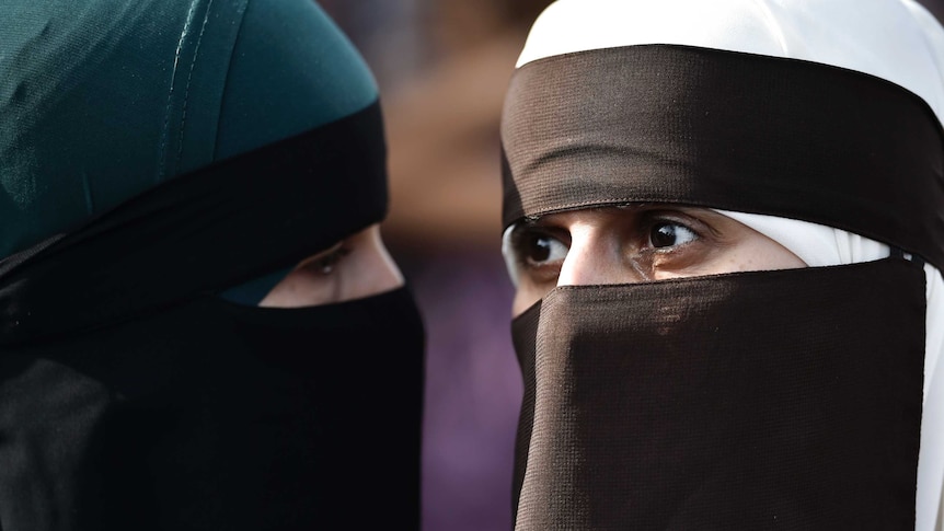 Two women wearing burkas.