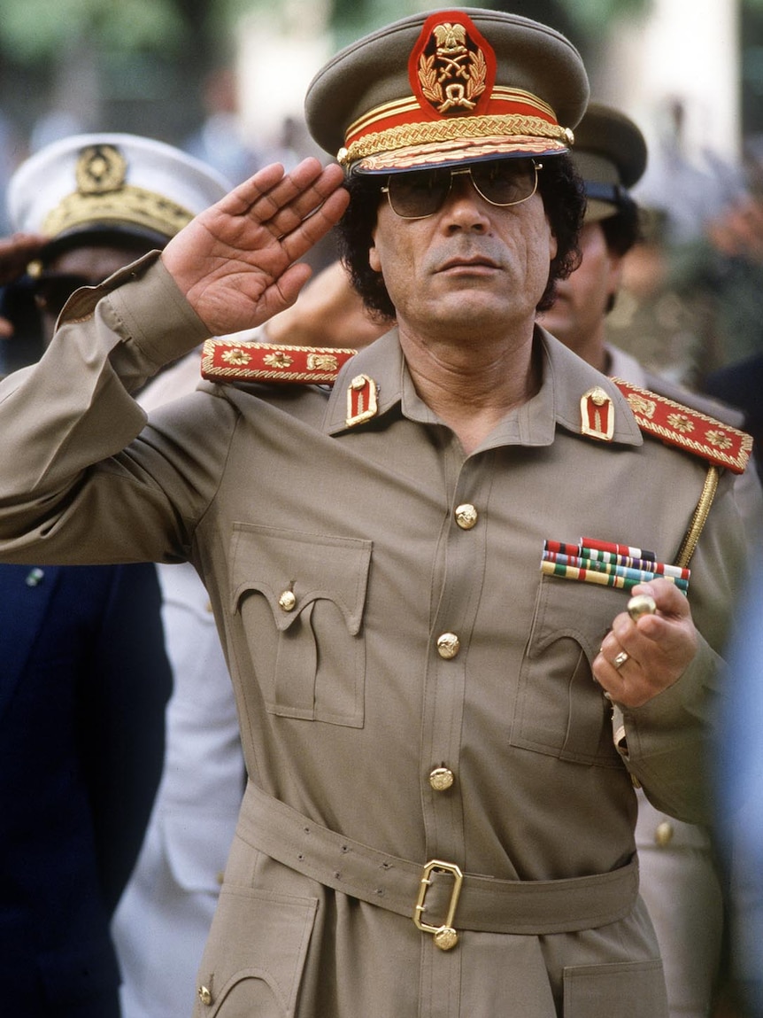 Moamar Gaddafi reviews troops in Dakar, Senegal, in 1985.