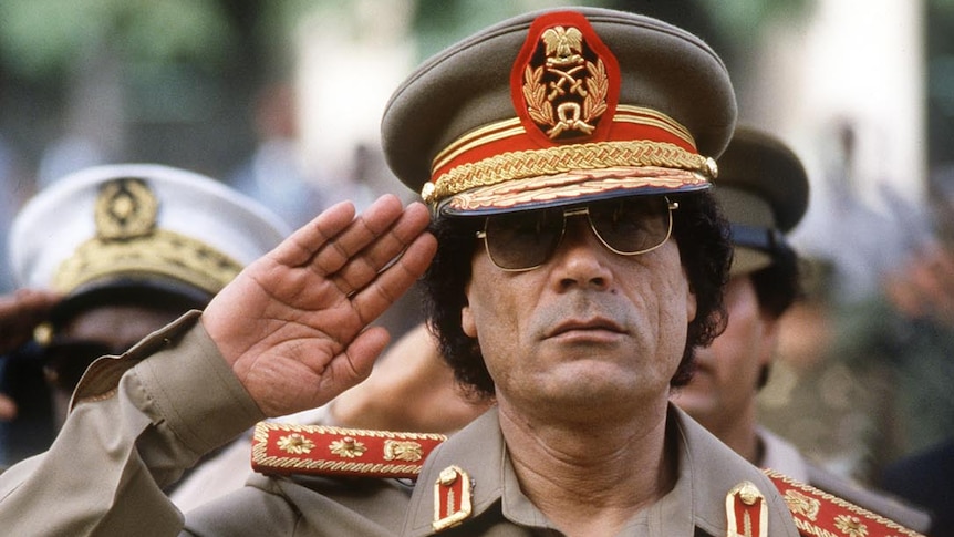 Moamar Gaddafi reviews troops in Dakar, Senegal, in 1985.