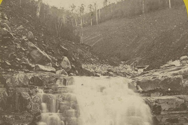 two black and white photos of white water running down rocks, the banks are bare