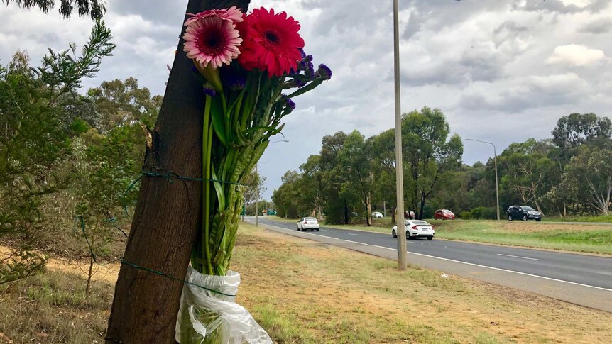 Flowers tied to a tree on Belconnen Way.