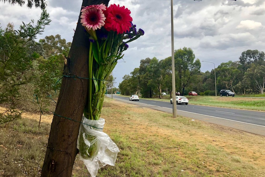 Flowers tied to a tree on Belconnen Way.