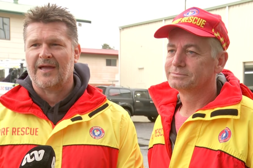 Two men in surf lifesaving outfits. 