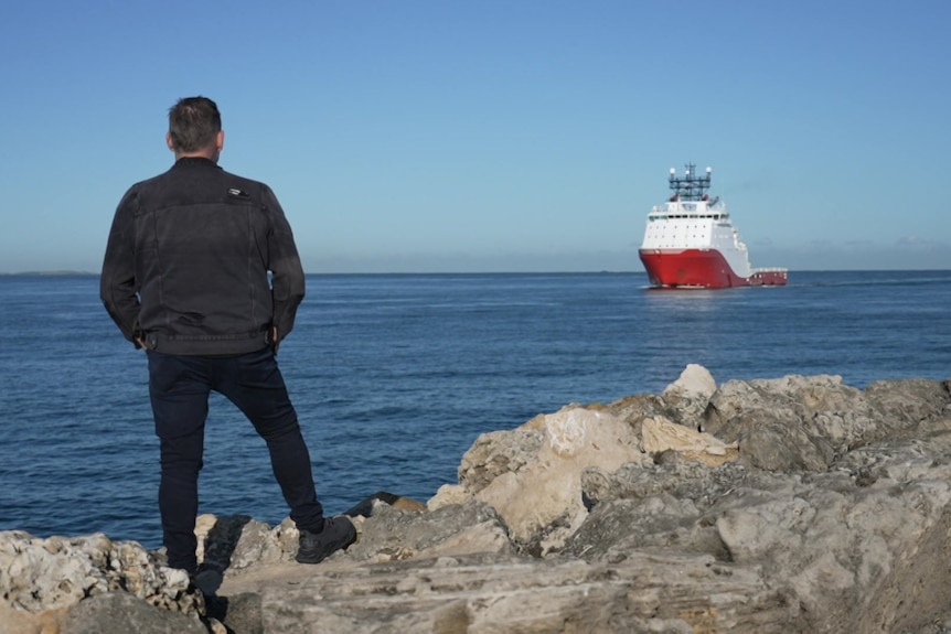 Travis Adams and a ship in the distance