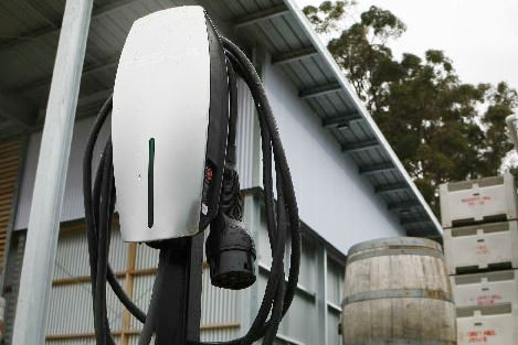 A power point stand for battery powered cars in front of winery entrance