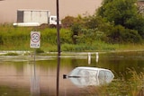 A car sits in floodwaters at Billinudgel