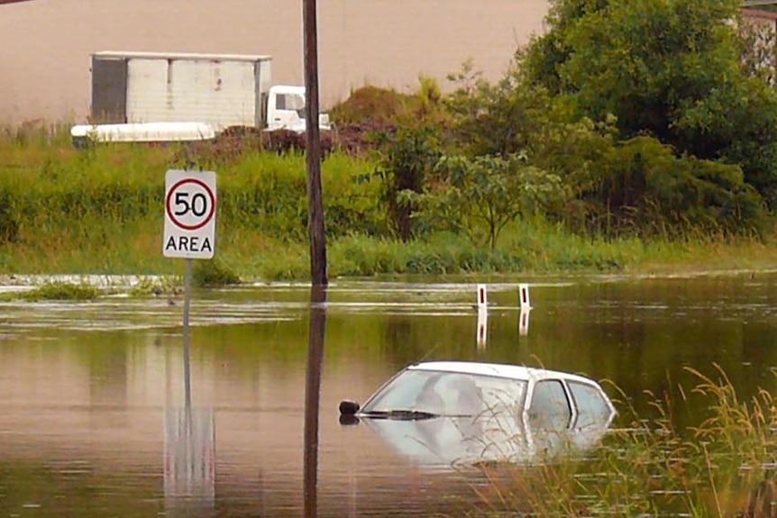 A car sits in floodwaters at Billinudgel on the north coast of NSW on Christmas Day.