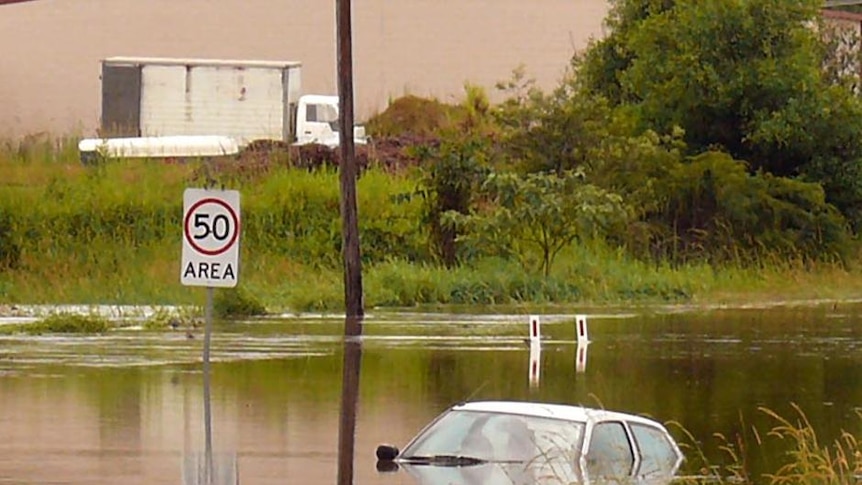 A car sits in floodwaters