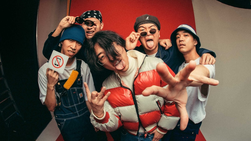 1300 (5-piece korean-australian rap crew) posing together with big facial expressions