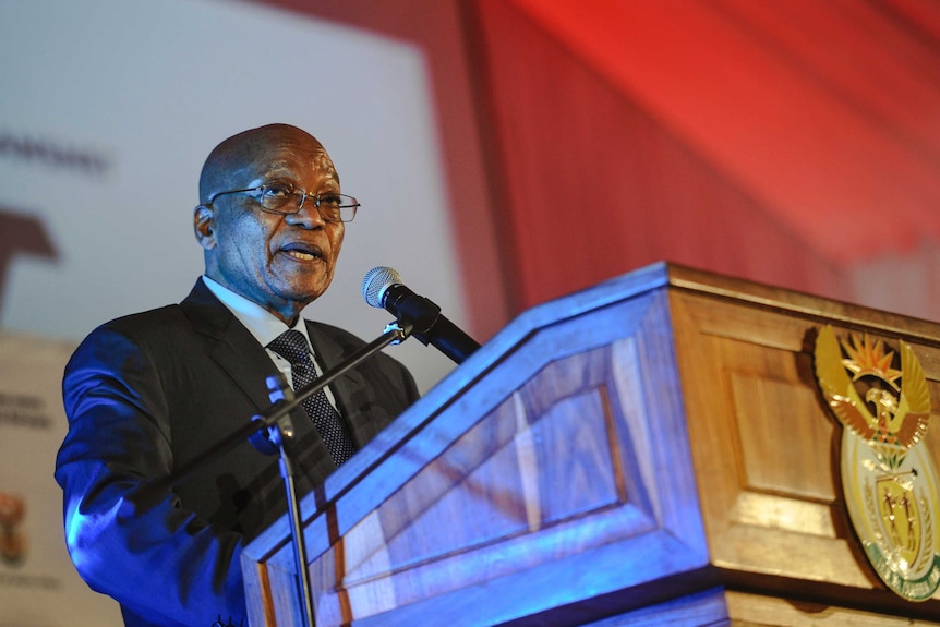 South African President Jacob Zuma speaks at a lectern.