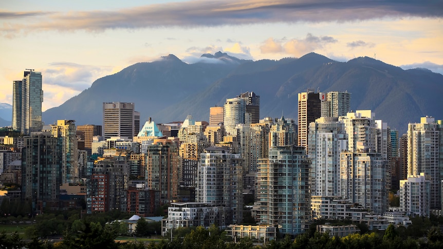 A photo of Vancouver's skyline and snow-capped mountains in the distance
