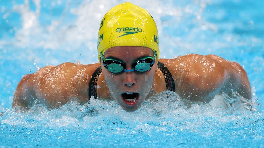 An Australian female swimmer competing in the heats of the 100 metres butterfly at the Tokyo Olympics.
