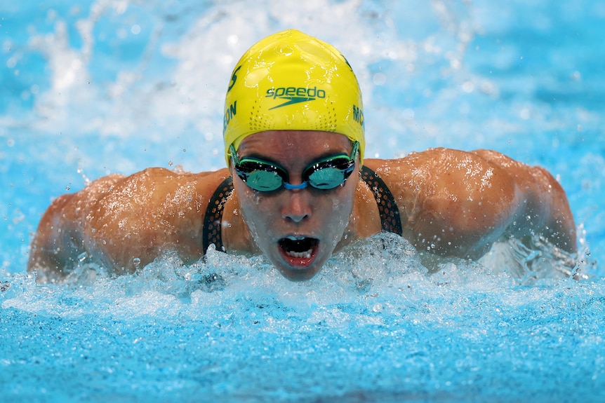 An Australian female swimmer competing in the heats of the 100 metres butterfly at the Tokyo Olympics.