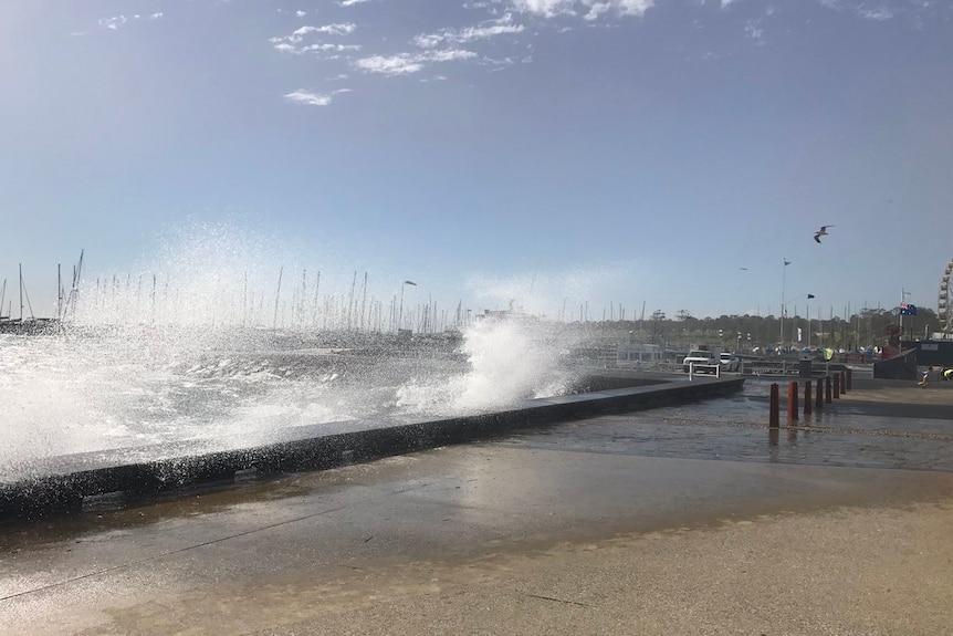 Waves whipping up along the Geelong foreshore wall.