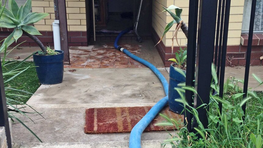 A burst main flooded houses at Valley View in Adelaide, requiring pumping to remove the water.