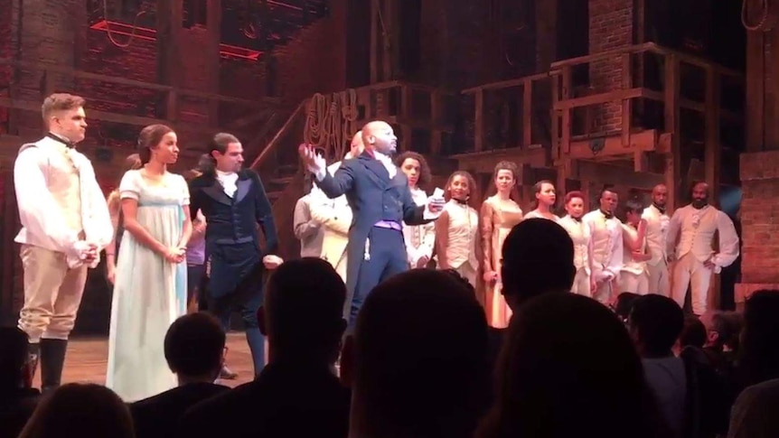 Brandon Victor Dixon is surrounded by castmates from Hamilton as he reads a statement to Vice-President elect Mike Pence