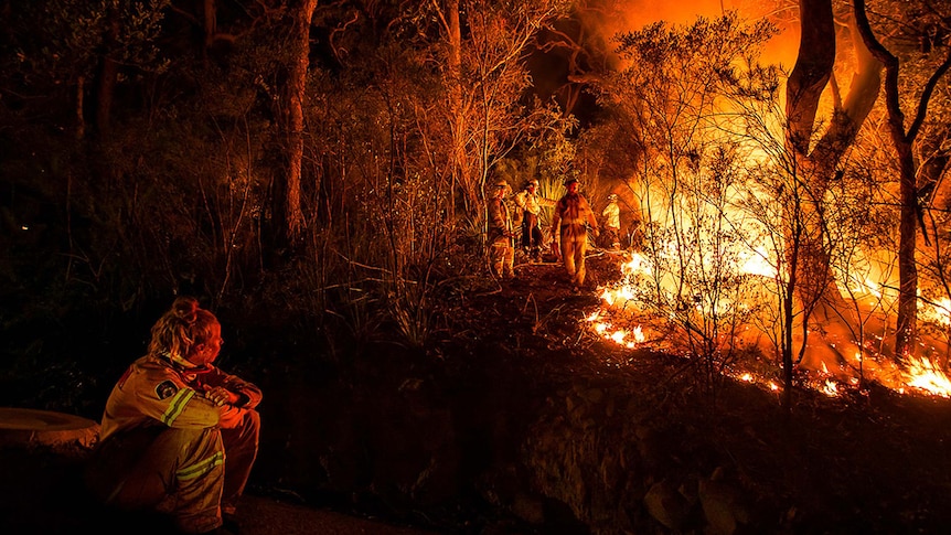 A firefighter sits down.