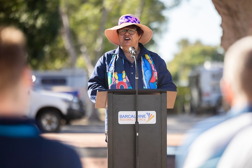 Woman holding a microphone speaking