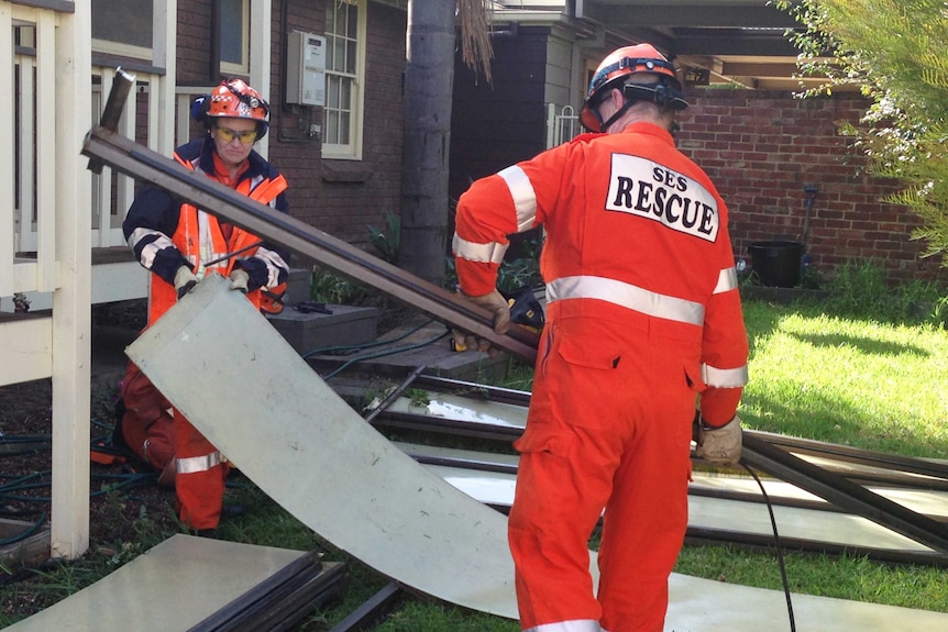 SES personnel clean up after damaging winds