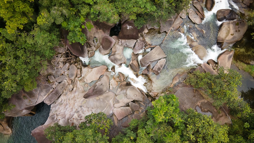 Dangerous swimming hole with large rocks and swift water