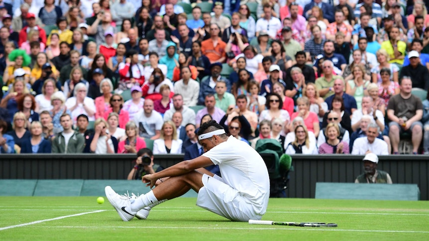 Kyrgios sits on the turf during loss to Andy Murray