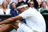 Kyrgios sits on the turf during loss to Andy Murray