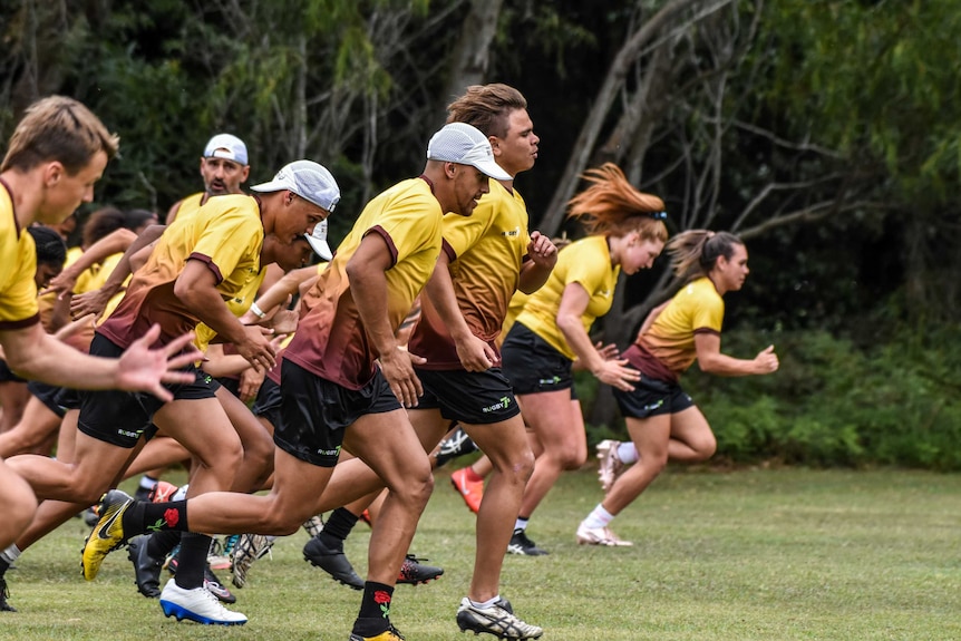 A group of rugby players are running.