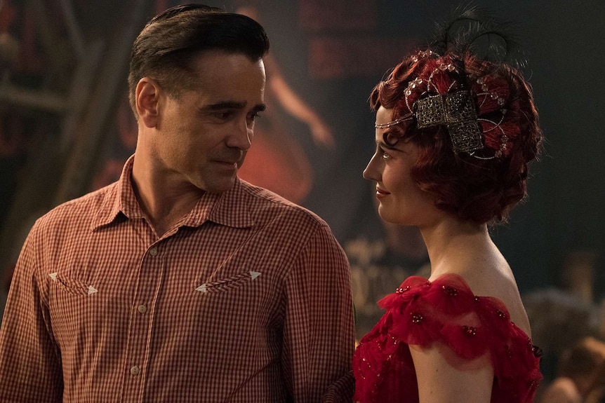 The two actors, in period appropriate costume, stare at eachother affectionately, Green in an elaborate crystal fascinator.