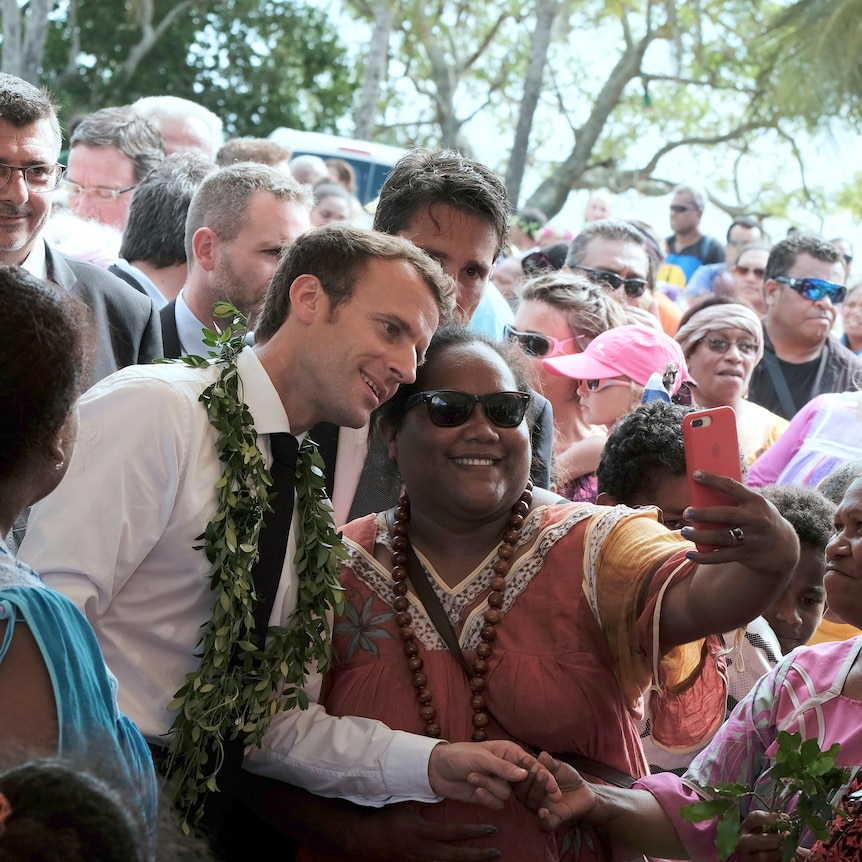 Macron taking a selfie with residents of New Caledonia.