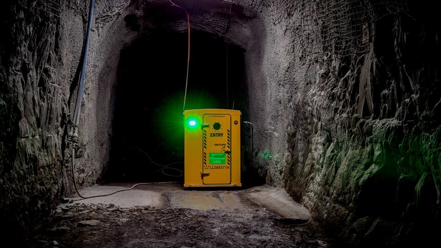 The yellow shelter in the mine with a green light.