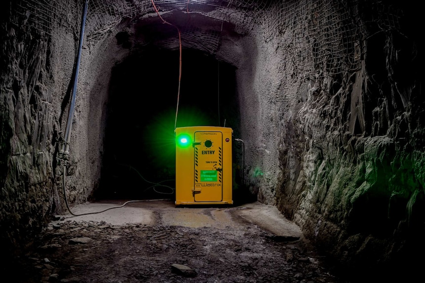 The yellow shelter in the mine with a green light.