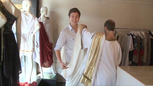 Men shop for togas in clothing store
