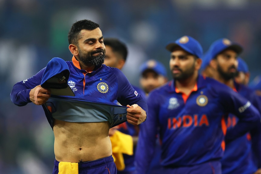 Virat Kohli puffs out his cheeks and pulls up his shirt in frustration