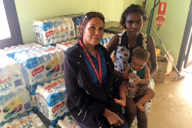 Pandanus Park CEO Patricia Riley and two community members with a delivery of bottled water.