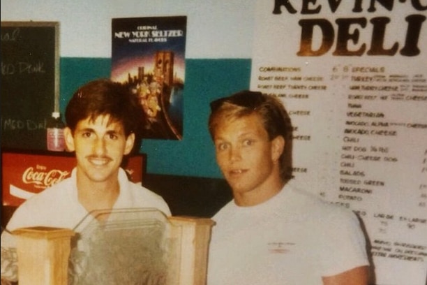 an old photo of a young Kevin McCarthy behind a deli counter