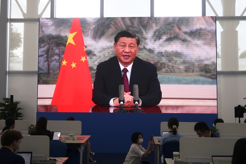 Xi Jinping on the screen. 