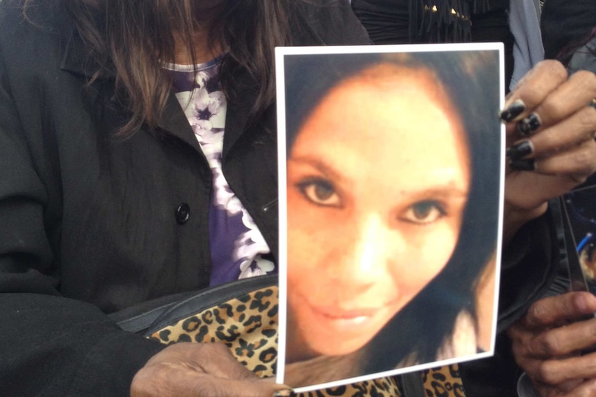 Ruby Kickett holding a picture of her murdered daughter Colleen Ford