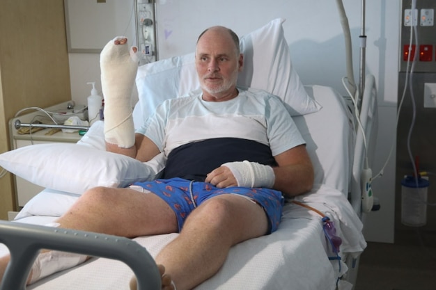 Man in hospital with two bandaged hands. 
