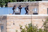 Police SWAT officers surround the Sikh Temple of Wisconsin.