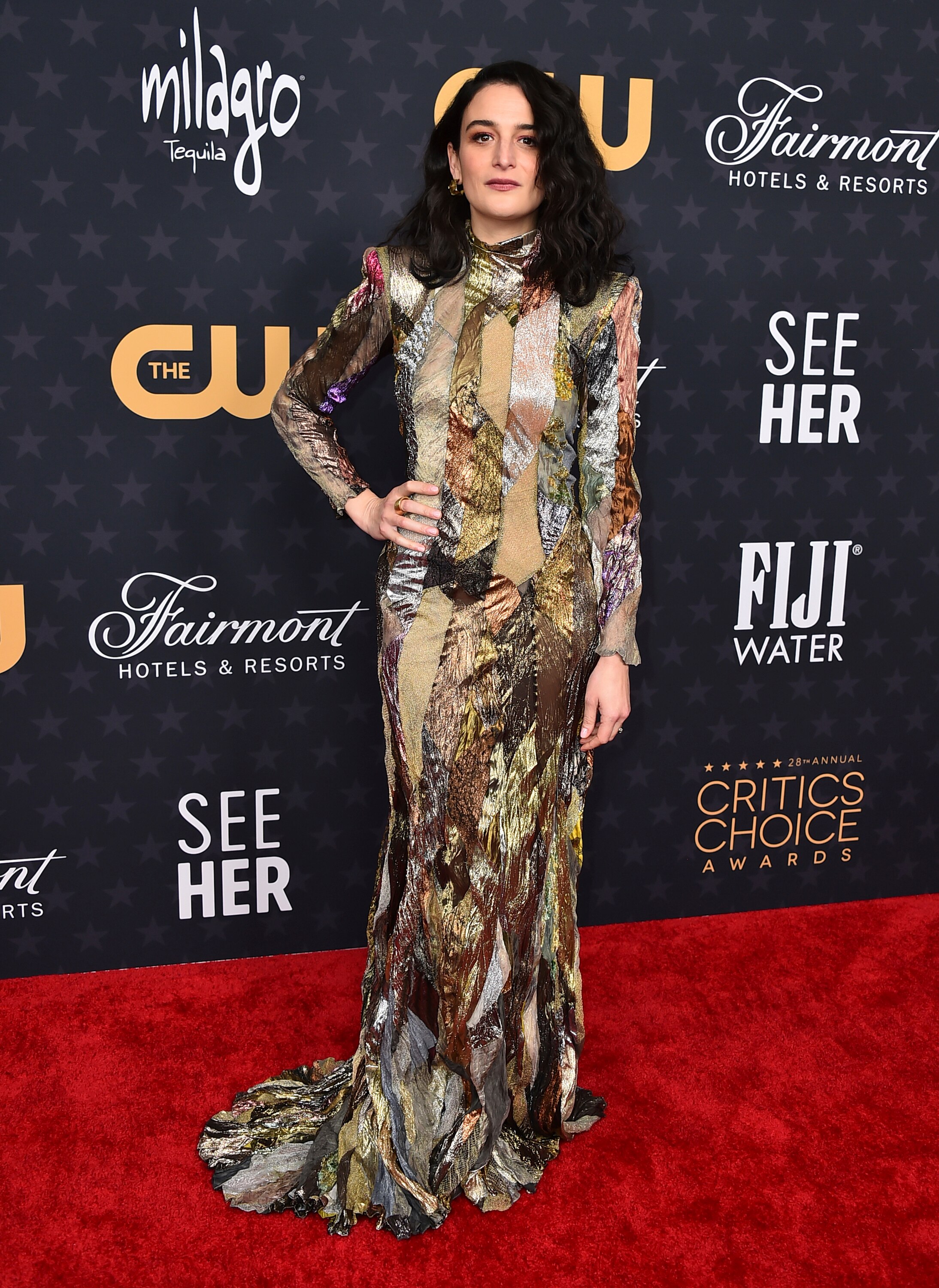 A brunette woman in a multi-coloured dress