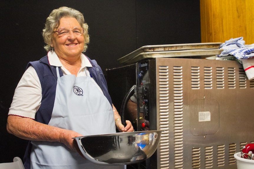 CWA member Val Knight is one of the valued scone bakers who sits by a small oven and makes scones daily by hand.