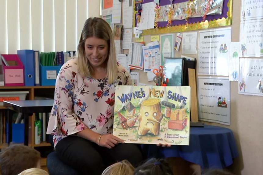 Meg Sampson reads Wayne's New Shape to students.