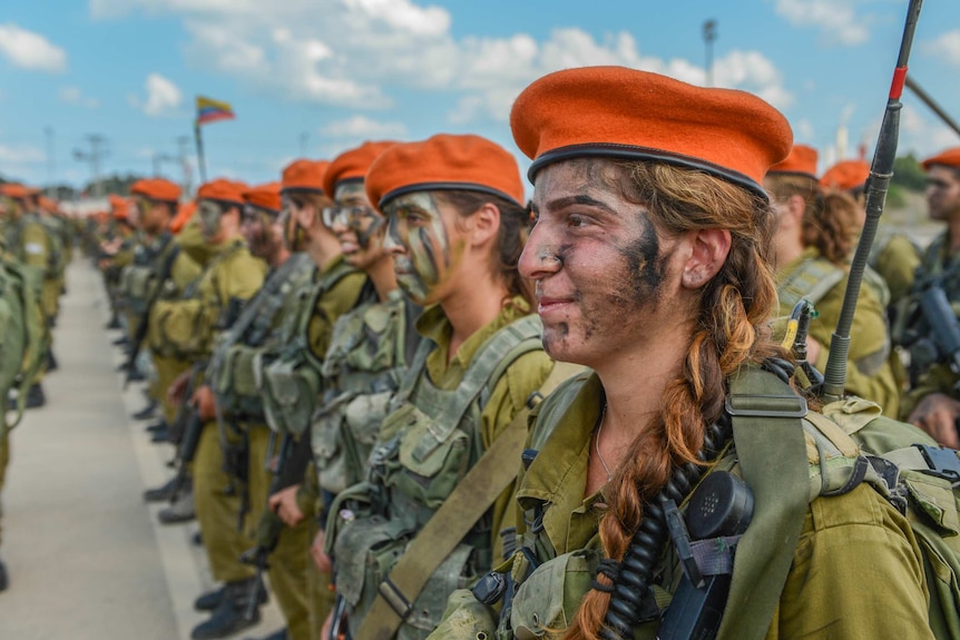 Female Israeli soldiers stand in orderly lines.