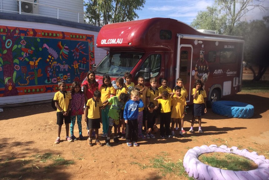 a group of kids standing with the motorhome