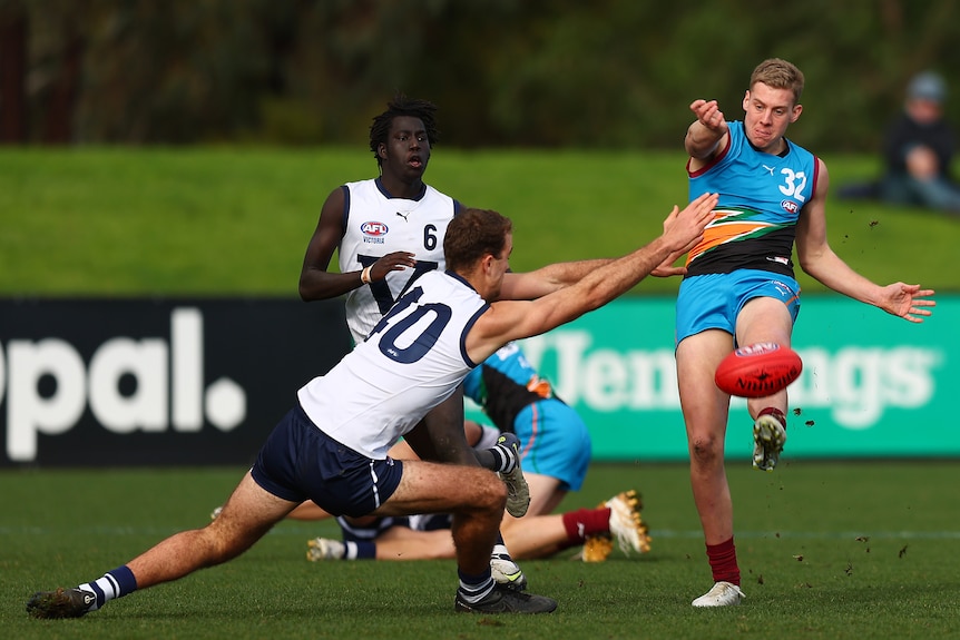 Arie Schoenmaker snaps the ball around his body as a defender tries to smother