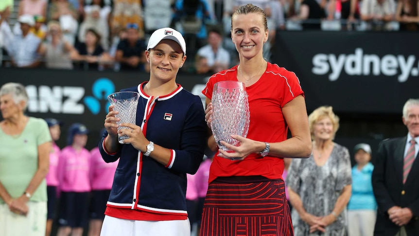 Winner Petra Kvitova and runner-up Ash Barty hold trophies after the Sydney International final.